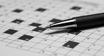Close up shows a crossword puzzle and sleek black pen, highlighting puzzle solving and mental acuity.