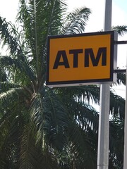 Close-up view of ATM sign with blurred nature background, ideal for financial content, icons, or...
