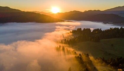 Sunrise over misty mountain valley