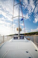Sailing yacht anchored near uninhabited islands in Croatia, captured from the bow. Peaceful summer...