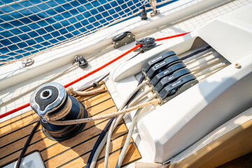 Close-up of rope clutches and winches on the deck of a sailing yacht near Croatia. Sailing equipment, control systems and technical detail of life at sea.