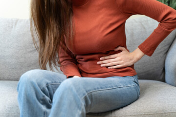 asian young woman intolerance hand in stomach ache, suffer from food poisoning, abdominal pain and...