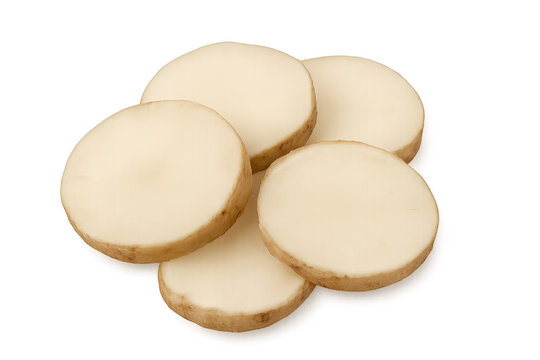 Jicama root slices arranged neatly, displaying crisp white texture and clean circular cuts on clear surface