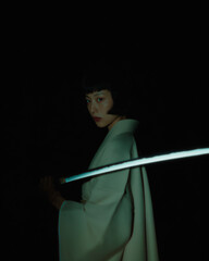 Mysterious Woman with Katana in Dim Lighting