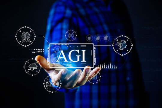 person's hand holding a digital display of "AGI" surrounded by AI and technology icons, symbolizing Artificial General Intelligence and future technological integration.