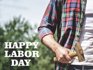 Happy Labor Day. Handsome man and hand tools. Closeup, outdoors. Sun day, Congratulations for family, loved ones, friends and colleagues. Concept of preparation for the national holiday
