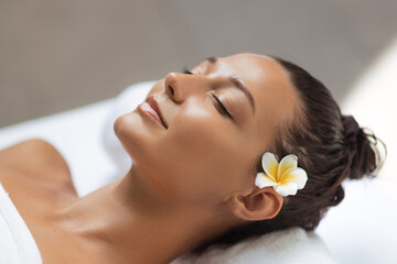 Beautiful Woman with Glowing Skin Relaxing During Facial Spa Treatment