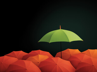 A black umbrella stands out from the crowd of dark umbrellas, with an orange one in between them. The background is plain and simple, highlighting the contrast between these two colors .,