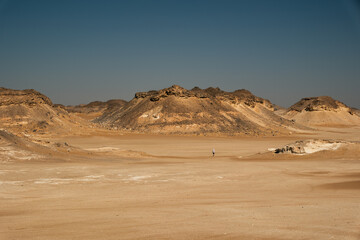 Ash-covered hills in Egypt's Black Desert under a clear sky, scenic and remote landscape. Volcanic	