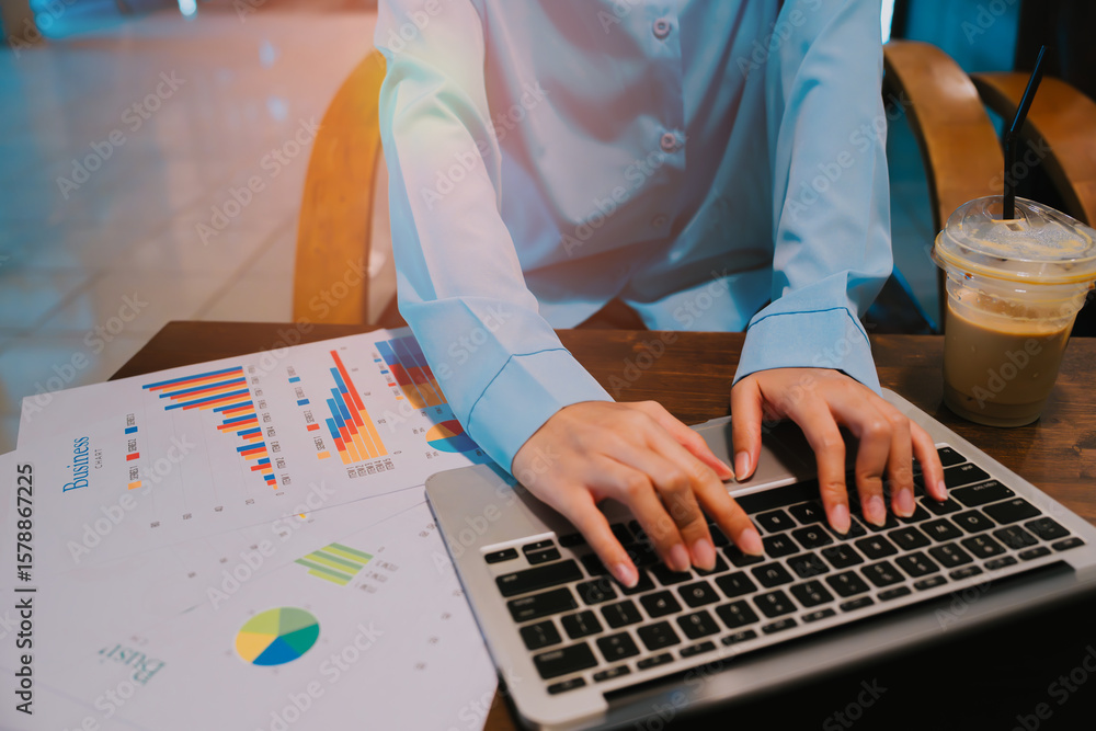 Poster business professional analyzing data on laptop with charts and coffee in a modern workspace setting