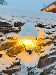 Lamp post with snow cap in winter forest, serene atmosphere