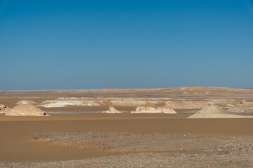 White rock formations and sand dunes in Egypt's White Desert, natural desert landscape	