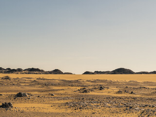 Ash-covered hills in Egypt's Black Desert under a clear sky, scenic and remote landscape. Volcanic	
