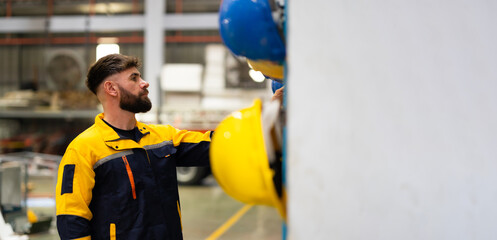 Factory workers pick up safety helmets to start work : Caucasian man Professional Mechanical...