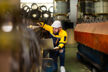 Laptop computer : blue collar working production line : Caucasian man engineer worker working...
