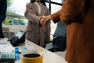 Business men and women shake hands confidently professional investor working with new startup...