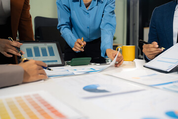 Businessmen team or financial data analysts working with tablets and laptop computers and data...