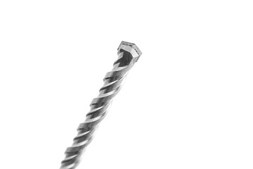 Close-up of a metallic drill bit with a twisted design, showcasing its sharp tip and hexagonal...