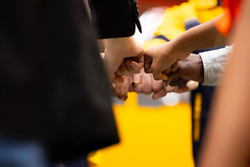 diverse people putting hands together. Unity and teamwork concept. Professional Mechanical Engineer team Working at metal sheet profiling factory. Industrial production