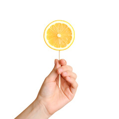 Child’s hand holding stick with lemon slice on pastel transpare background.