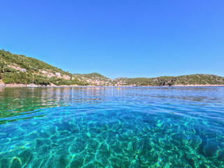Crystal Clear turqouise blue waters at Kantina beach, near Kioni, small village in Ithaca island, Ionian sea, Greece