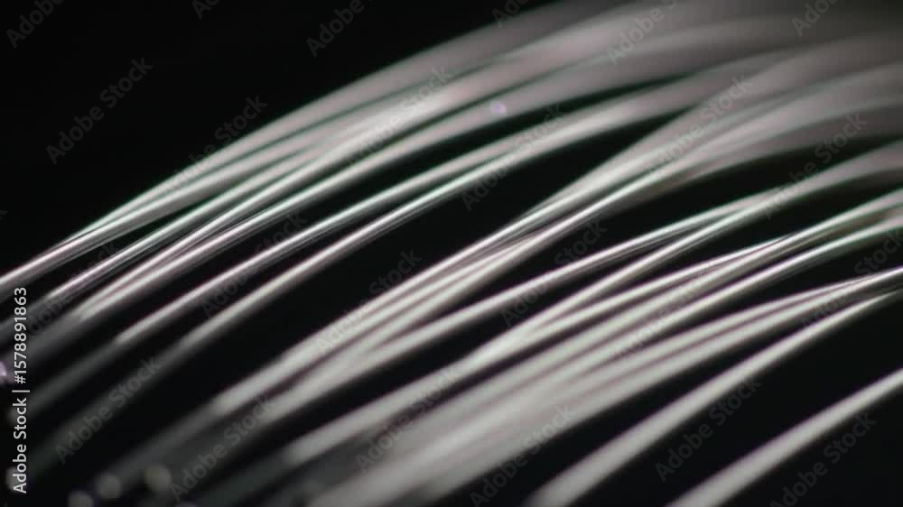 Poster close up of white silver strands in bundle curved pattern on dark background