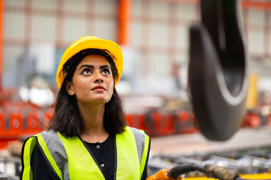 remote control overhead crane : Indian female engineer worker working control sheet metal roof machine at metal sheet profiling factory. Industrial production. Maintenance of factory machinery - Powered by Adobe