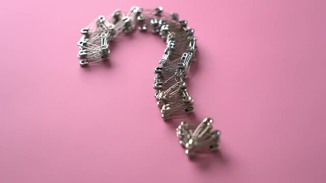 Silver Wired Question Mark on Pink Background Conceptual Art and Symbol of Inquiry