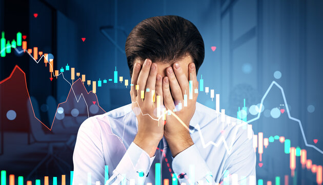 Businessman facepalming with collapsing stock market charts and red arrows symbolizing global financial crisis and economic downturn overlayed on screen.