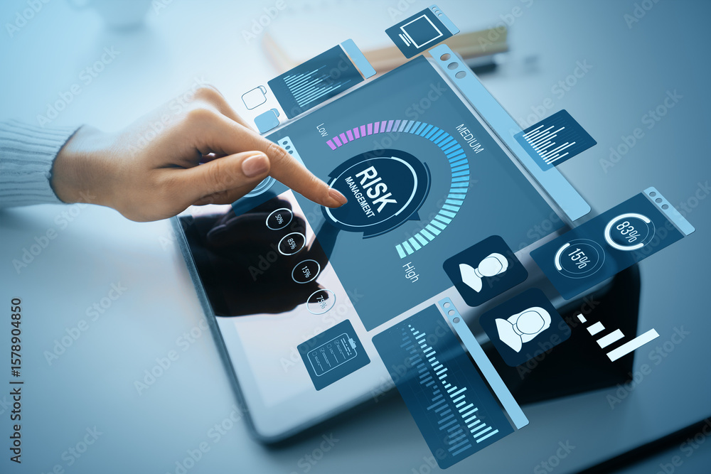 Poster hand interacting with digital risk management interface on tablet with financial data and corporate 