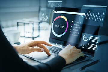 Businessperson analyzing financial data on digital dashboard with infographics and charts on laptop...