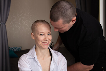 Smiling Bald Woman After Shaving Head.Emotional Support and Care During Cancer Journey at Home