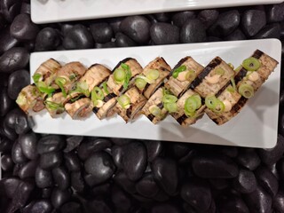 Appetizing Sushi Rolls Served on a White Plate with Creative Presentation