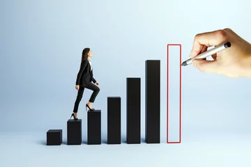  Businesswoman climbing bar graph steps as hand draws final growth column on blue background representing success and corporate progress. © Who is Danny