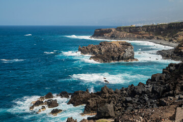 beautiful view of the beach ocean shore with rocks and cliffs with beautiful waves on the island of Tenerife Canary Islands Spain