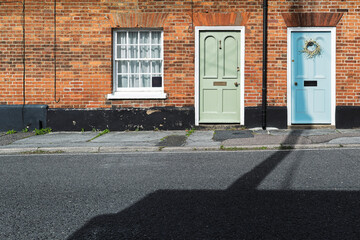 Abstract view of colourful front wooden doors seen on typical British terraced houses in summer....