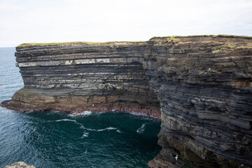 Experience the breathtaking coastal cliffs that majestically overlook the stunning turquoise waters