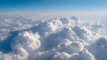 Fototapeta premium Fluffy cumulus clouds viewed from airplane above the sky. 