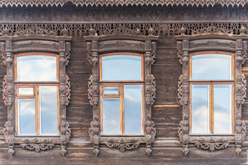 Fragment of the facade of a wooden russian house of the 19th century with carved decor based on folk architecture