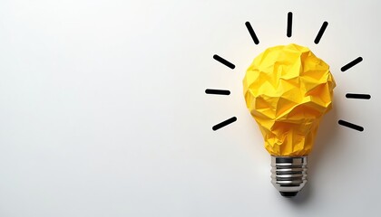 Creative idea concept, illustrated by yellow crumpled paper light bulb with black lines on white backdrop. Metaphor for innovative thinking, creative process, brainstorming, solution, new ideas.