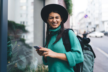 Smiling brunette woman, 30, interacts with a tablet, engaging with technology in a relaxed posture,...