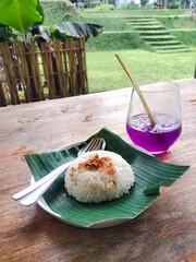 Sticky rice with butterfly pea tea on the woode table