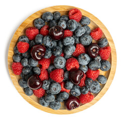 The High resolution fruit photo of mixed fruits including cherries, raspberries and blueberries arranged on a plate, taken with split focus technique.
