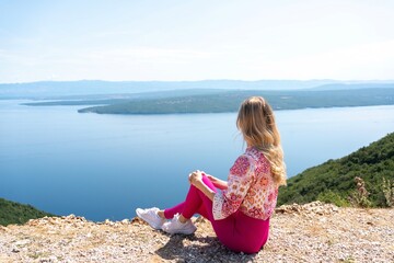 Woman enjoying scenic sea view from high viewpoint on Cres island. Digital detox, freedom and...
