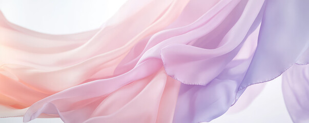 Obraz premium Soft, flowing pastel colored fabric gently drapes in mid-air with a sense of graceful motion. Delicate elegance and fluidity
