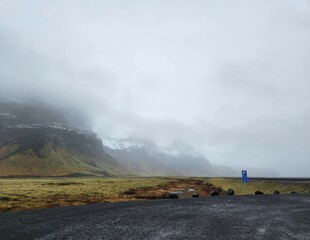 Misty Icelandic Landscape with River and Volcanic Highlands on a Windy Day