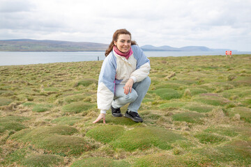 A Young Woman Delights in the Beauty of Nature Surrounded by a Lush Green Landscape