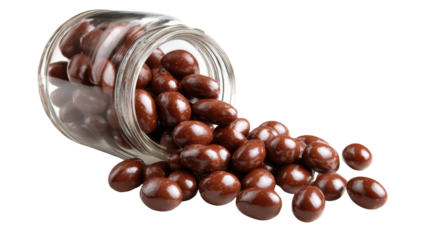 Delicious chocolate candies spilling from a jar, perfect for satisfying sweet cravings.