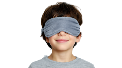 Happy boy wearing a sleep mask, smiling, isolated on white background.