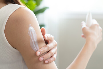 Health skin care, beauty smile asian young woman, girl  hand applying, putting moisturizer on her...
